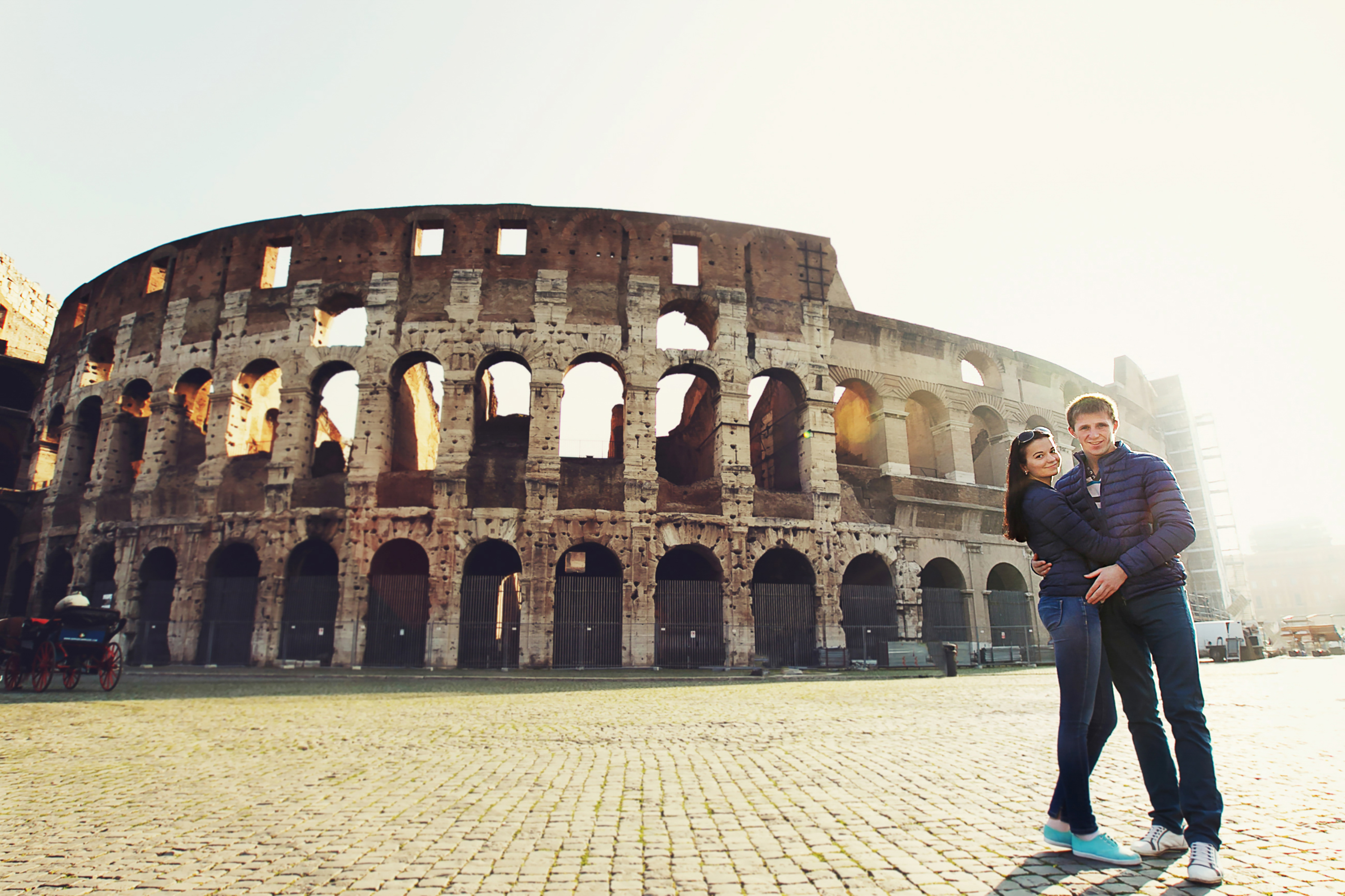 Two people standing near Coliseum in Rome